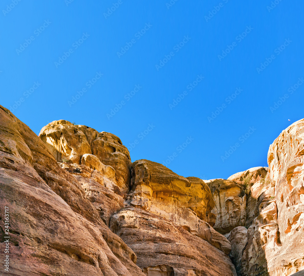 Rocks in mountains of Petra on sunny day Rocks in mountains of Petra on sunny day