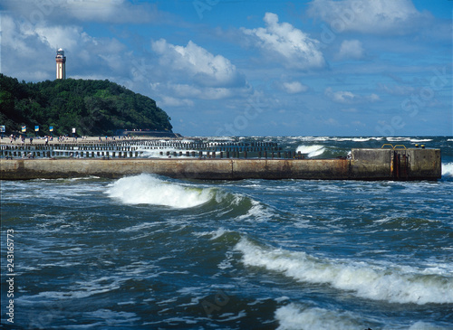 Lighthouse and beach in Niechorze, Baltic sea, Poland photo