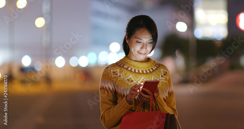 Canvas Print Woman go shopping and use of mobile phone at the street
