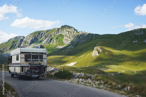 Euro-trip. Old stylish classic motorhome on the road in the mountains.  © Evgenii Starkov
