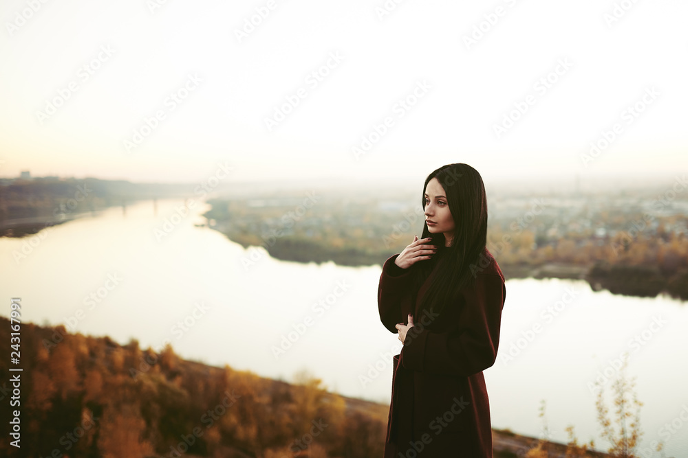 Strict brown-haired woman in the autumn park Strict brown-haired woman in the autumn park