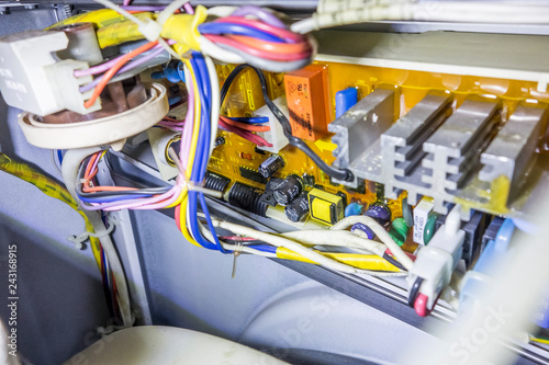 Washing machine repair, view of microcircuits, wires, lamps.