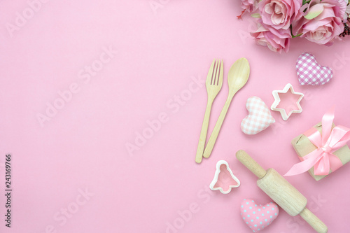 Table top view aerial image of decoration valentine's day background concept.Flat lay essential items love with cooking items with rose on modern pink paper.blank space for mock up creative design.