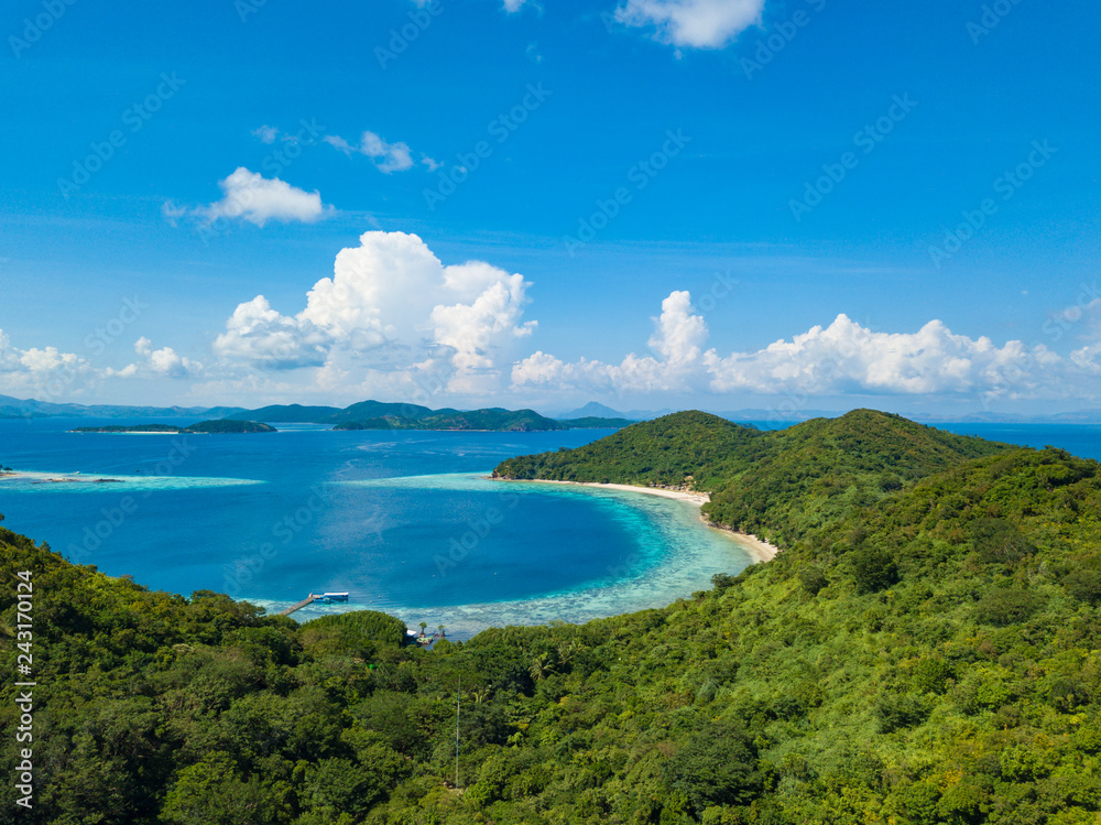 Aerial view of tropical island Bulalacao. Beautiful tropical island with white sandy beach, palm trees and green hills. Travel tropical concept. Palawan, Philippines