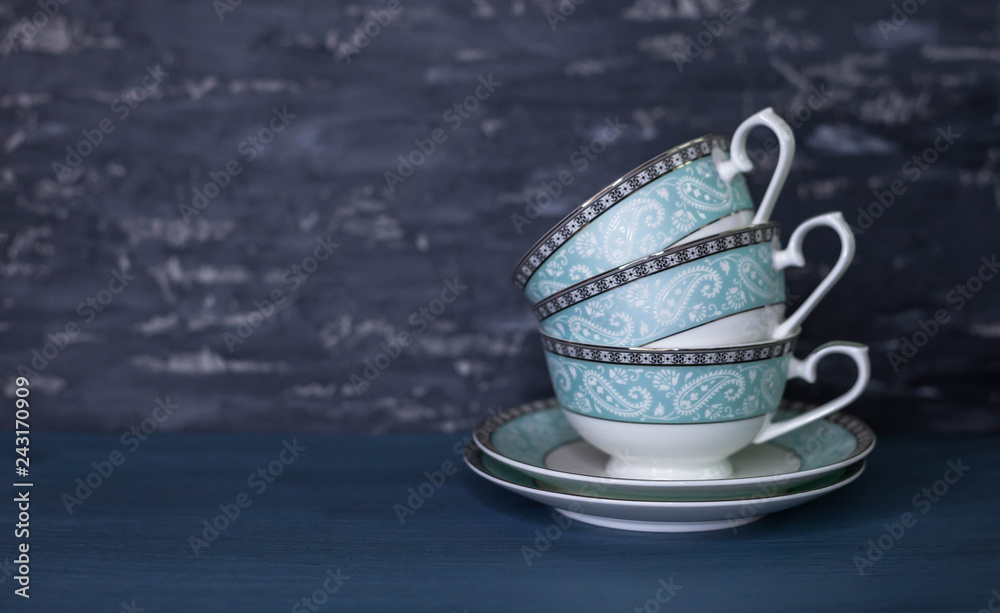 Stack of antique tea cups, isolated on white. Beautiful porcelain. Stack of antique tea cups, isolated on white. Beautiful porcelain.