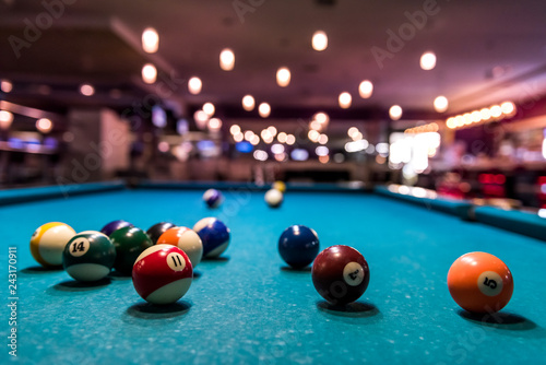 Colorful billiard balls on playing table, dispersed