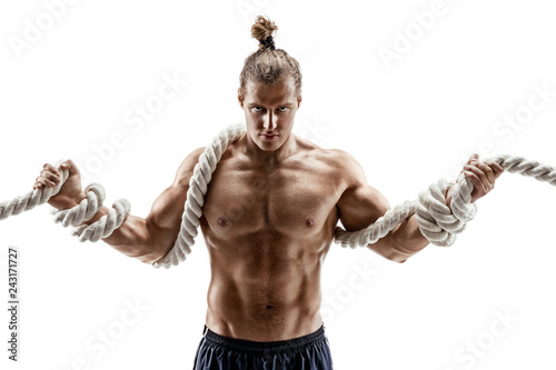 Strong muscular man working out with heavy ropes. Photo of young man shirtless isolated on white background. Strength and motivation