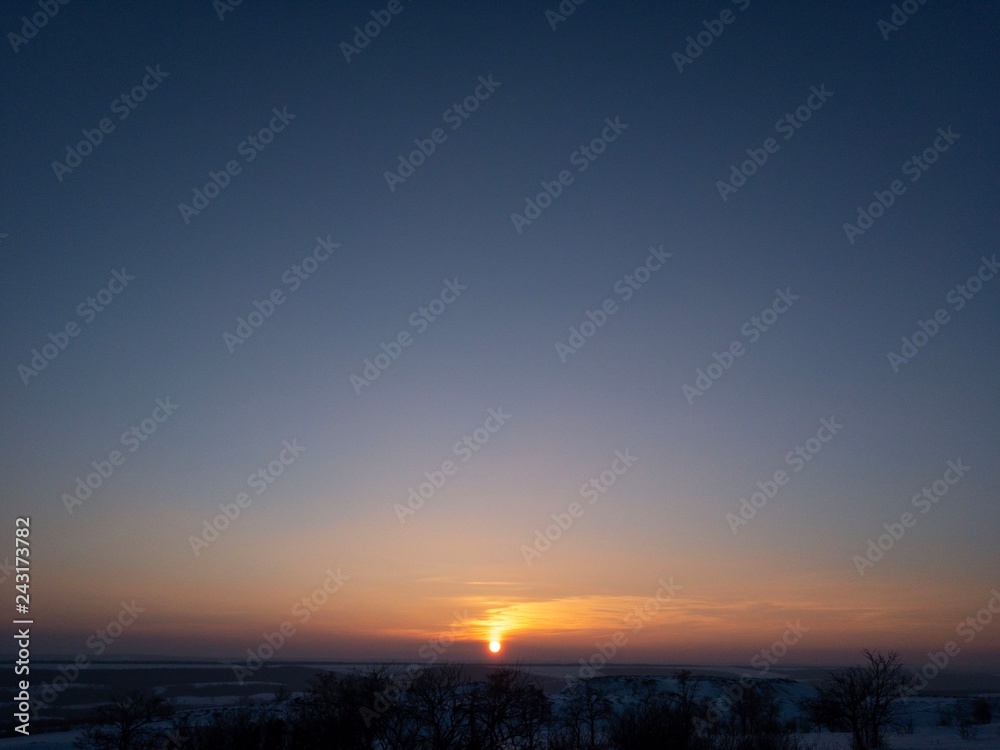 sunset over the field and blue sky