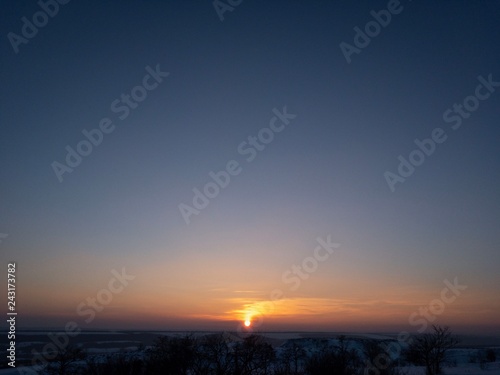 sunset over the field and blue sky