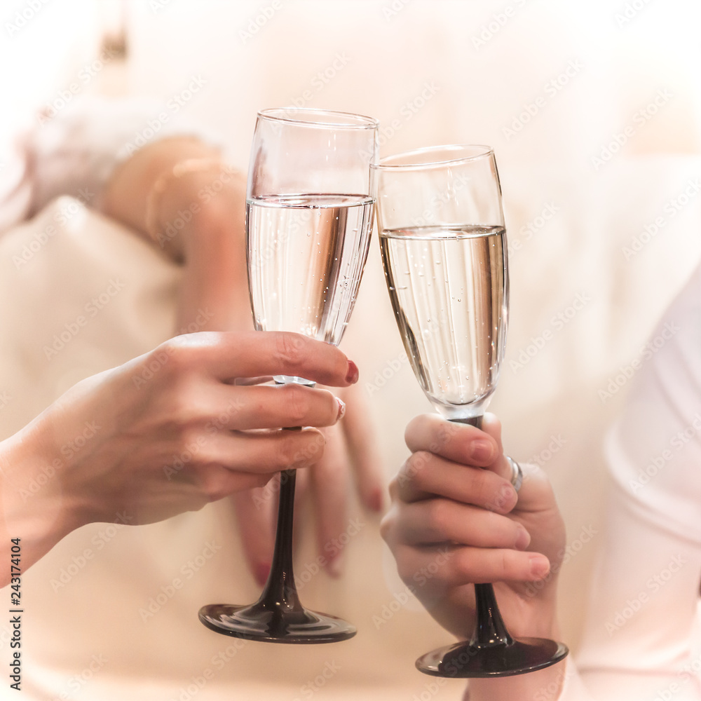 two hands holding glasses filled with champagne, white wine, clinking glasses, Stock Photo | Adobe Stock
