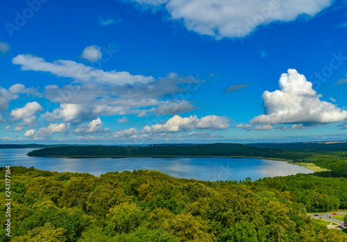 View over forests on the island of Rügen, Germany, on dramatic clouds towering over the water.