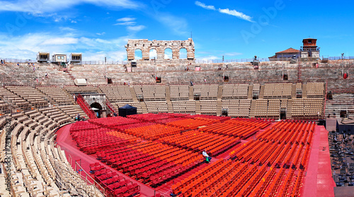 Inside of Arena of Verona in Italy / 
Red seats under blue sky in the theater photo
