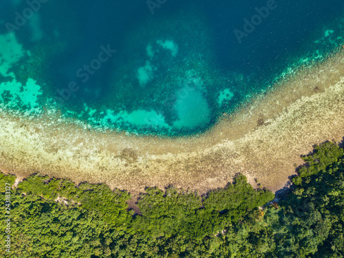 Aerial top view of tropical island Bulalacao. Beautiful tropical island with white sandy beach  palm trees and green hills. Travel tropical concept. Palawan  Philippines