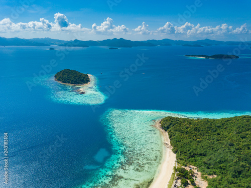 Aerial view of tropical island Bulalacao. Beautiful tropical island with white sandy beach, palm trees and green hills. Travel tropical concept. Palawan, Philippines photo