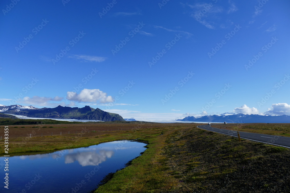 Reflection in a lake next to the ring road on a glorious sunny day, Iceland