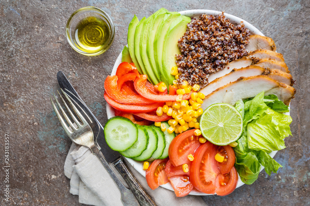 Healthy salad bowl with quinoa, tomato turkey, avocado, sweet pepper, corn, lime and mixed greens, top view. Healthy food conception. Superfood meal. Healthy salad bowl with quinoa, tomato turkey, avocado, sweet pepper, corn, lime and mixed greens, top view. Healthy food conception. Superfood meal.