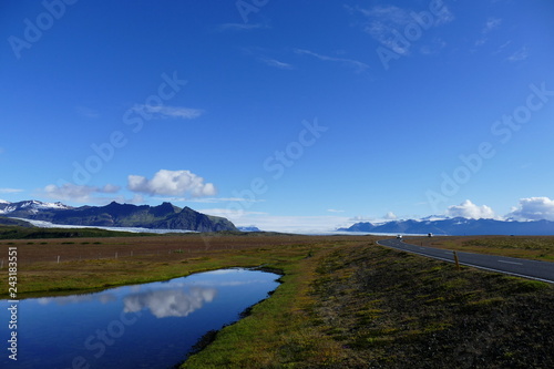 Reflection in a lake next to the ring road on a glorious sunny day  Iceland