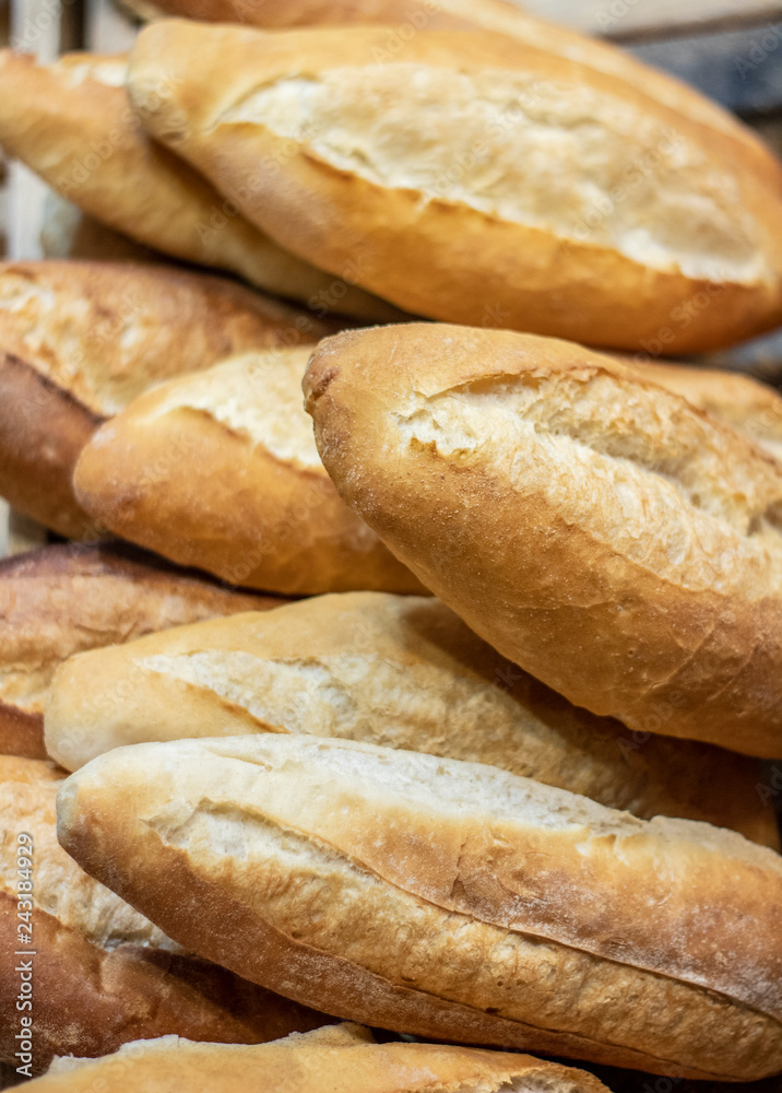 Display of handmade bread loaves on the counter top of a modern bakery to entice customers to buy