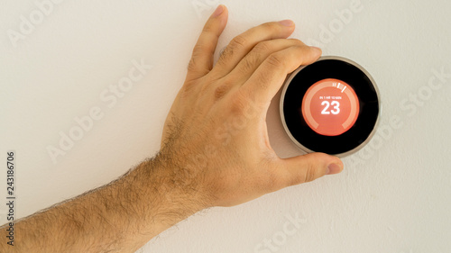Принти на полотні Close up of a wall thermostat being adjusted.