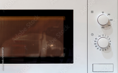 Turned on classic microwave oven. Closeup.