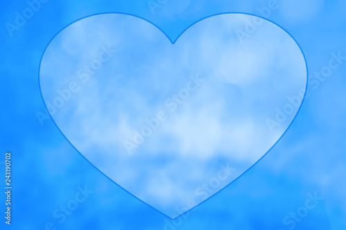 Drawn heart in center of blue sky at clear day. Natural background with painted heart with cloudy texture with copy space. Cloudy sky with love symbol close-up. Valentine day image in pastel tones.
