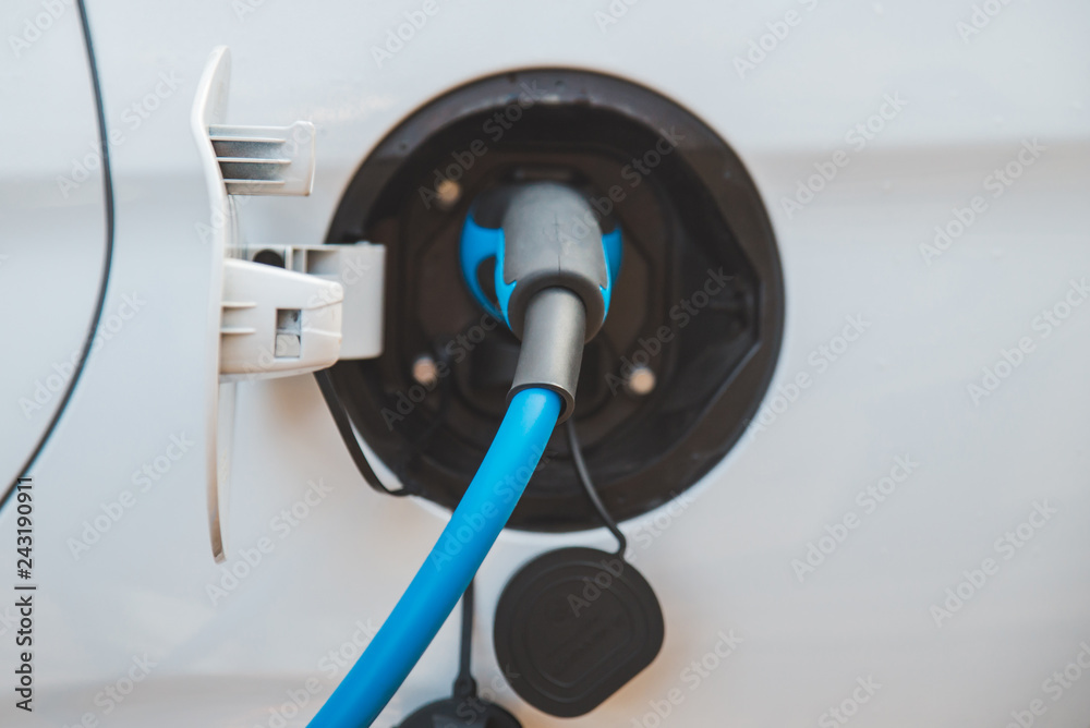 charging car at city parking. ecological alternative charging car at city parking. ecological alternative