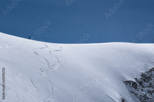 Single skier on top of snowridge waiting to drop in © Magnus