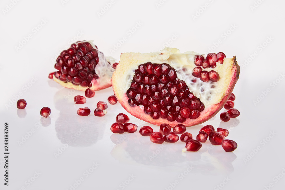 Close-up of pomegranate seeds texture on a white background, top view. Ripe red garnet fruit Close-up of pomegranate seeds texture on a white background, top view. Ripe red garnet fruit Close-up of pomegranate seeds texture on a white background, top view. Ripe red garnet fruit Close-up of pomegranate seeds texture on a white background, top view. Ripe red garnet fruit