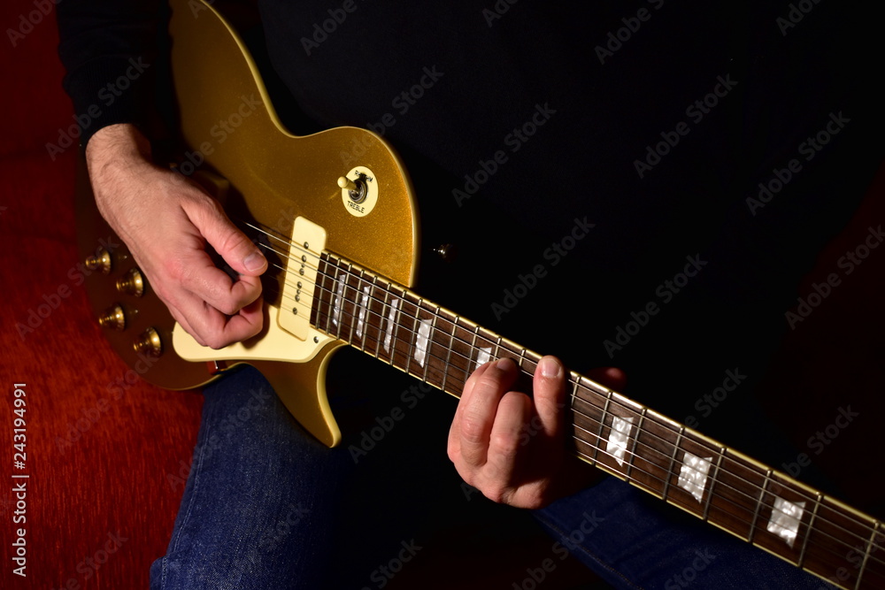 Man playing a electric guitar. Closeup, no face.
