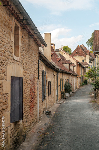 Fototapeta Naklejka Na Ścianę i Meble -  Medieval village of Aquitaine with its stone houses in the south of France on a cloudy day.