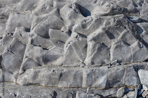 Texture of a dark gray stone or background for design..Surface of the rock with an abstract pattern.