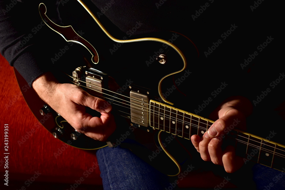 Obraz premium Man playing a electric guitar. Closeup, no face.