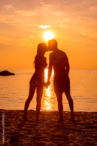 young couple is kissing at the sea