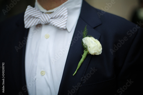 Groom in Blue Suit Jacket, White Carnation boutonniere, with blue seersucker bow tie Wedding Photography 