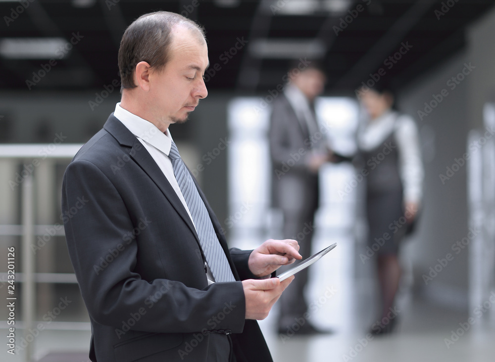 businessman uses a digital tablet in the office businessman uses a digital tablet in the office