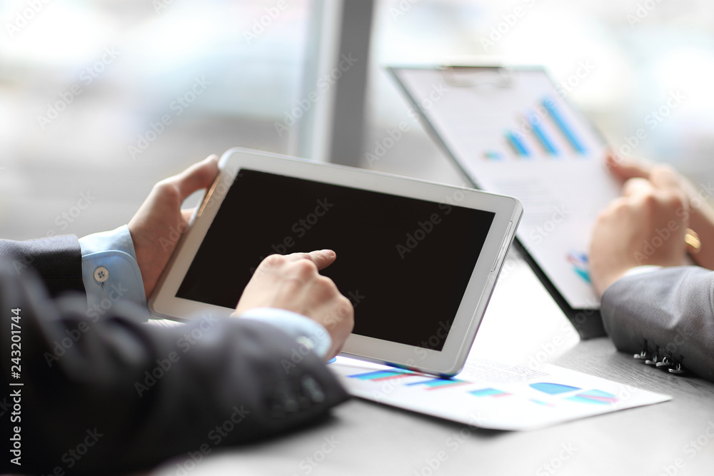 close up.the businessman uses a tablet computer at his Desk close up.the businessman uses a tablet computer at his Desk