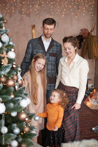 family photo near the elegant Christmas tree