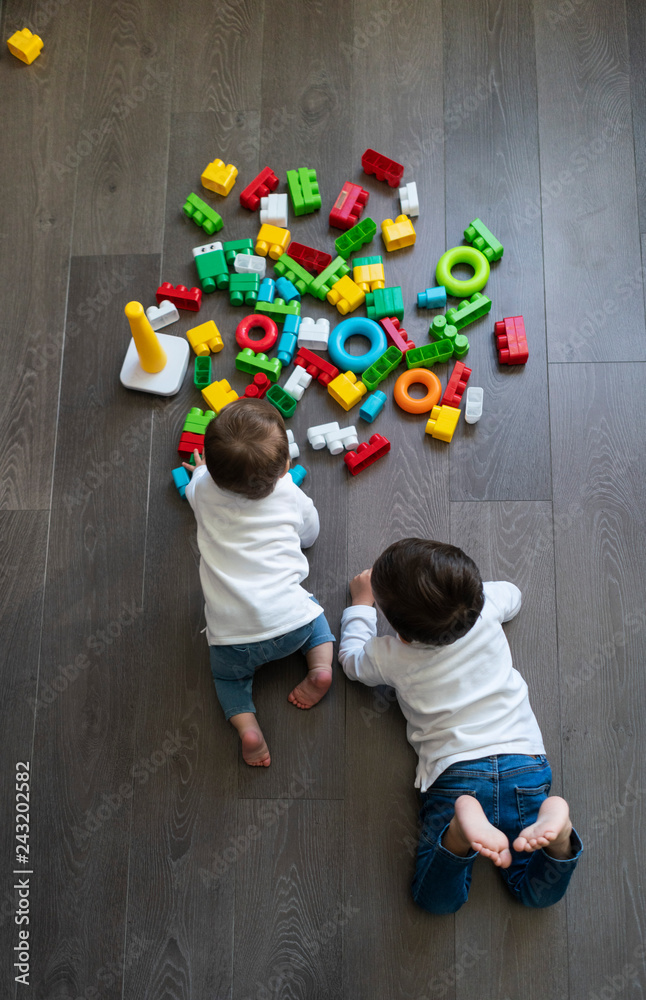 Two happy baby playing with toy blocks. Two happy baby playing with toy blocks.