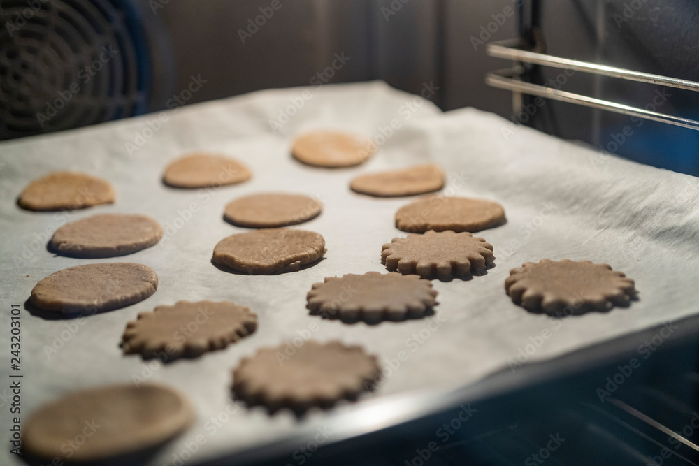 a lot of cookies and gingerbread on baking tray in an oven a lot of cookies and gingerbread on baking tray in an oven