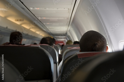 People sit in the aircraft cabin and waiting for departure