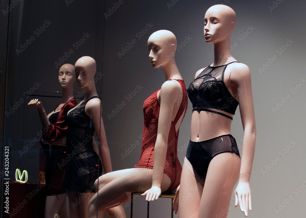 A number of mannequins in the windows of lingerie in red and black, lace  underwear on menekanas with backlight, beautiful combinations of panties  and bras Stock Photo | Adobe Stock