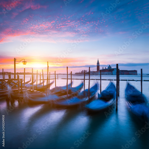 Moving gondola boats in harbor. Early morning with sunrise in Venice, Italy, Europe. © VOJTa Herout