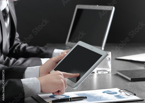 close up.businessman using digital tablet to check financial data