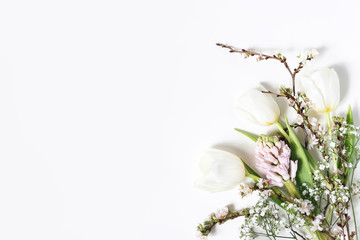 Easter floral frame, web banner. Spring wedding, birthday composition with pink hyacinth, cherry blossoms, tulips and baby's breath flowers. White table background. Decorative corner. Flat lay, top.