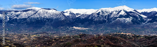 scenic winter landscape of the Italian Comino valley under the Marsicani mountain range