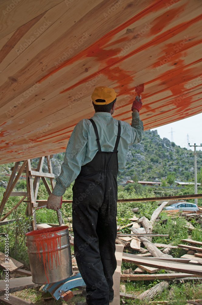 Workers repairing and painting with traditional wayto the Sailing wooden yacht at Selimiye Marmaris , Mugla Turkey Workers repairing and painting with traditional wayto the Sailing wooden yacht at Selimiye Marmaris , Mugla Turkey
