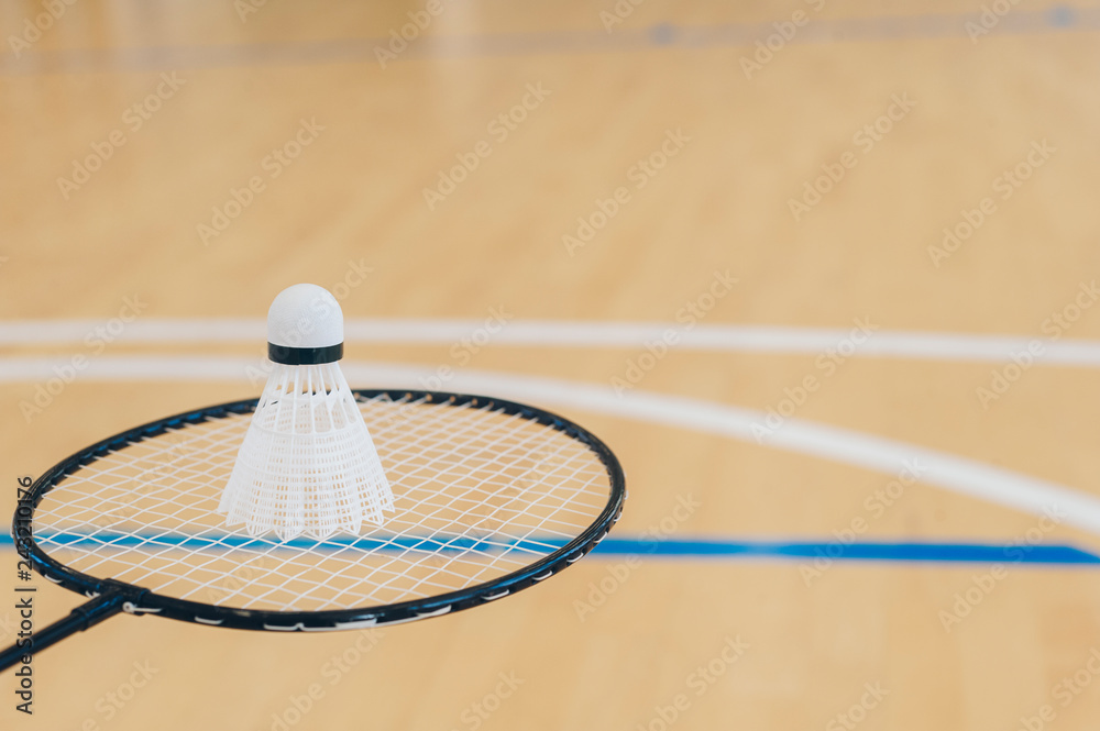 White badminton shuttlecock on a hall floor at badminton courts .Close