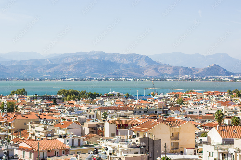aerial photography of south European small medieval city in Mediterranean landscape district with sea bay harbor town and foggy mountain ridge background silhouette  