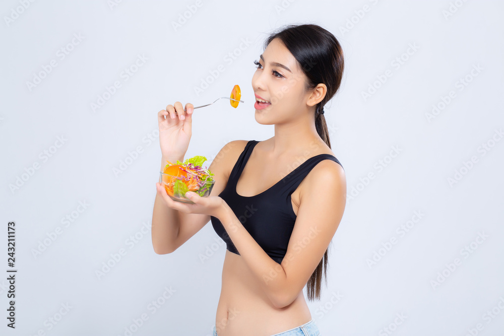 Beautiful portrait young asian woman smiling holding salad vegetable food isolated on white background, girl diet eating vegetarian for healthy, health care or wellness concept. Beautiful portrait young asian woman smiling holding salad vegetable food isolated on white background, girl diet eating vegetarian for healthy, health care or wellness concept.