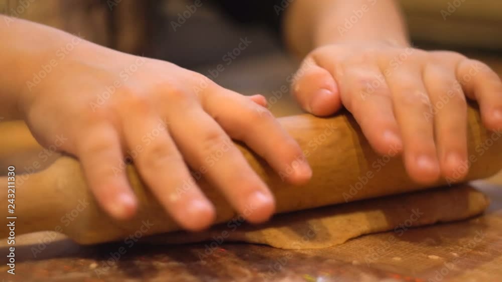 Kneading and rolling the dough on the table. White flour. Home cooking. Female hand. Close up. Cooking. Kneading and rolling the dough on the table. White flour. Home cooking. Female hand. Close up. Cooking.